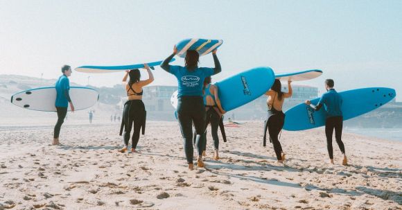 Wetsuit - Group of People Carrying Surfboards