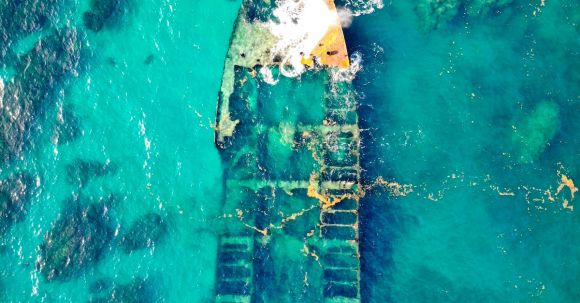 Sunken Ship - Aerial View of a Ship Wreck on Body of Water