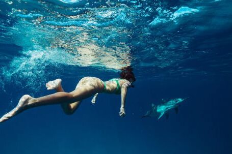 Snorkeling - Woman Swimming Underwater with a Shark