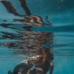 Snorkeling - Two People Wearing Flippers Swimming Underwater