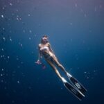 Snorkeling - Woman Diving in Deep Blue Water