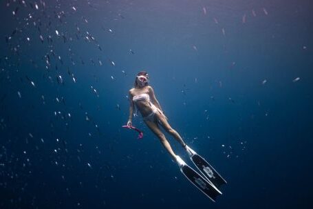 Snorkeling - Woman Diving in Deep Blue Water
