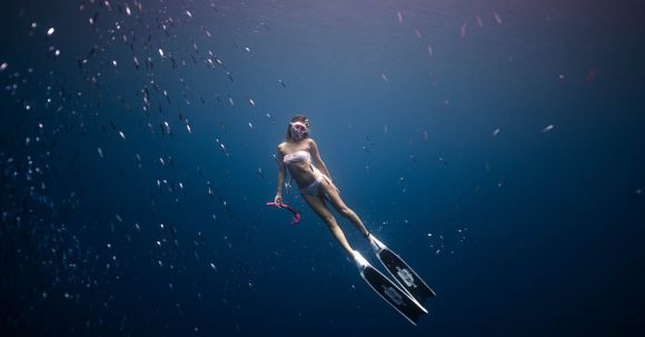 Snorkeling - Woman Diving in Deep Blue Water