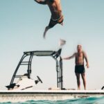 Diving - Photo of Man Jumping from Boat to the Sea