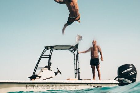 Diving - Photo of Man Jumping from Boat to the Sea