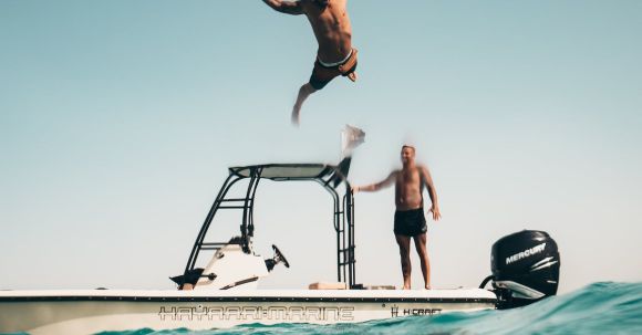 Diving - Photo of Man Jumping from Boat to the Sea