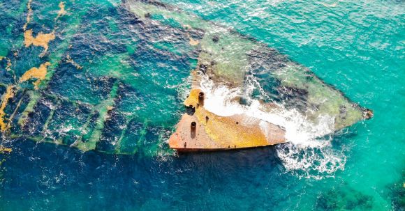 Sunken Ship - Aerial View of Shipwreck in the Middle of Ocean