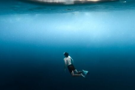 Snorkeling - Underwater View of a Man Snorkeling Near the Surface