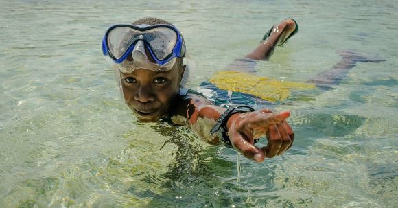 Diving Mask - A Boy Wearing a Diving Mask Swimming in the Water