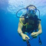 Diving - Man Carrying Air Tank in Body on Water