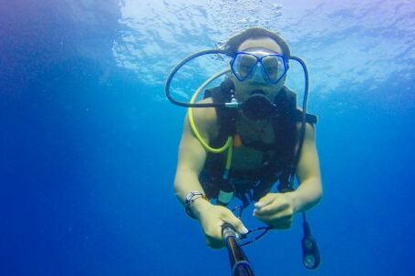 Diving - Man Carrying Air Tank in Body on Water