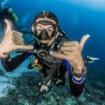 Diving - man underwater making hand signs