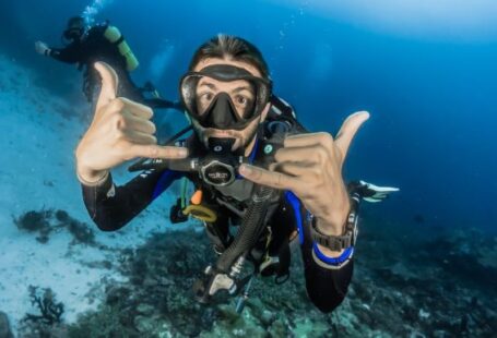 Diving - man underwater making hand signs