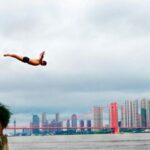Diving - Man Diving on Body of Water