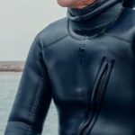 Scuba Diving - Man in Wetsuit Sitting Beside a Body of Water