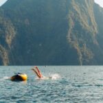 Diving Boat - A Person Diving into the Water from a Little Boat