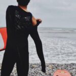 Wetsuit - Woman Holding Surfboard