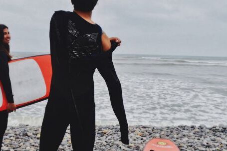 Wetsuit - Woman Holding Surfboard