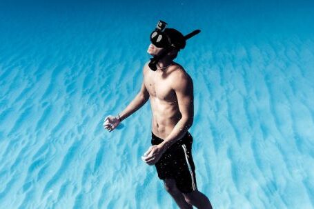 Snorkel - Unrecognizable man snorkeling in azure seawater