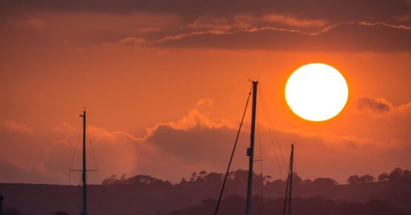 Marine - Boats Sailing on Sea during Sunset
