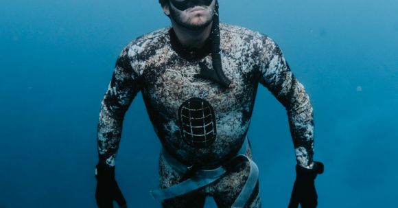 Diving Fins - Man in Drysuit Underwater