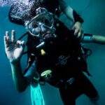 Diving - person wearing diving suit under water