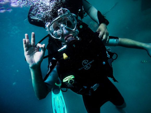 Diving - person wearing diving suit under water