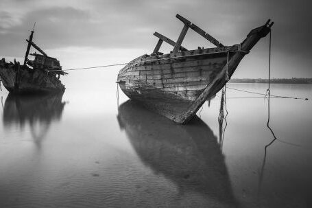 Sunken Ship - 2 Boats on the Body of Water Under Cloudy Sky during Daytime in Greyscale Photo