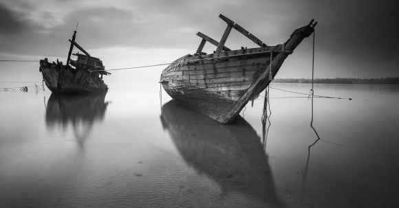 Sunken Ship - 2 Boats on the Body of Water Under Cloudy Sky during Daytime in Greyscale Photo