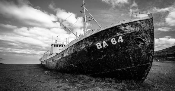 Sunken Ship - Grayscale Photography of Abandoned Cargo Ship on Field