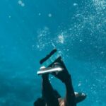 Snorkeling - Woman in Snorkeling Shoes Diving Underwater