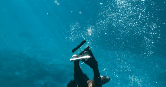 Snorkeling - Woman in Snorkeling Shoes Diving Underwater