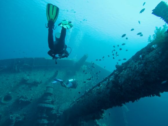 Shipwrecks For Diving - man wearing scuba diving swimming in water