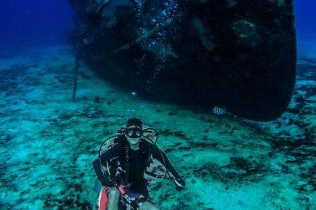 Shipwrecks For Diving - Scuba Diver Posing Near an Old Abandoned Ship Underwater