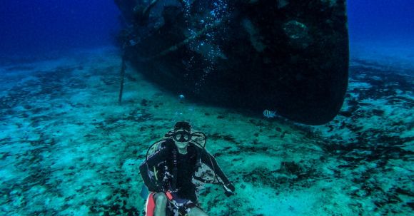 Shipwrecks For Diving - Scuba Diver Posing Near an Old Abandoned Ship Underwater